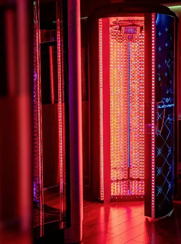 Red light therapy tanning bed with illuminated red LED panels